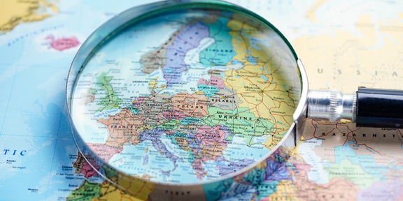 Lens on top of Europe map, credit Sasirin Pamai, Shutterstock