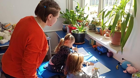 Ukrainian children drawing with teacher