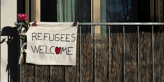 Support sign for refugees hanging on a balcony